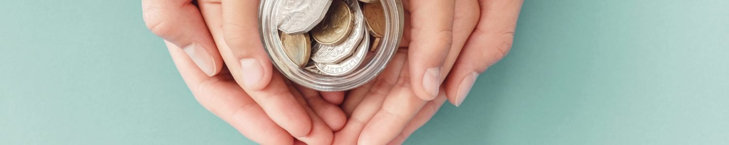 child and parent hands holding money jar, donation, saving, family finance plan concept